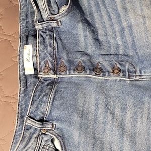 Distressed button fly flare jeans
